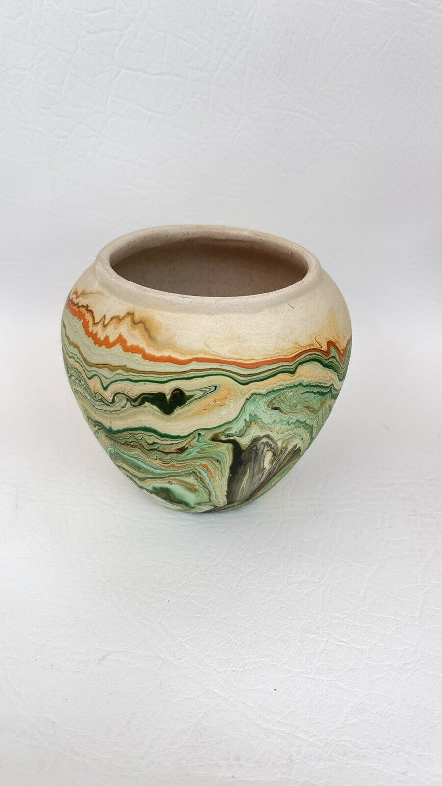 Nemadji Pottery Vase Shades Of Green Orange On Tan Background  4” Tall 4.5” Wide